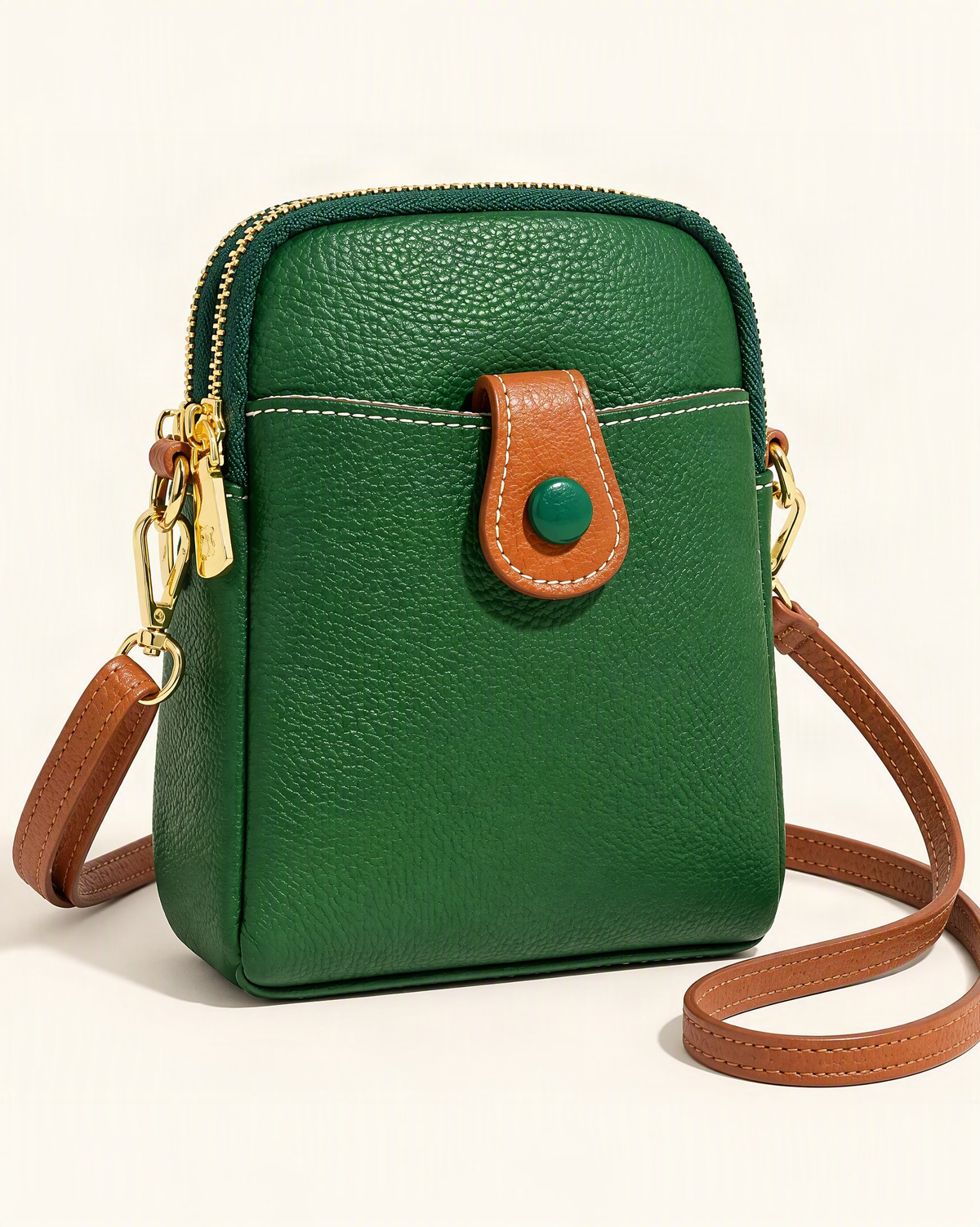 Cowhide Micro Crossbody Phone Bag with Detachable Strap — front three-quarter view on a warm white background