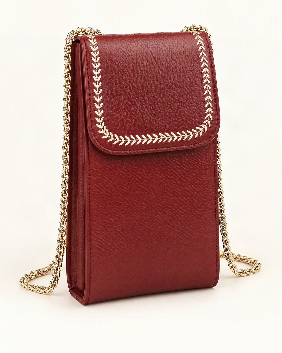 Top-Grain Cowhide Micro Crossbody Phone Bag with Chain Strap — front three-quarter view on a warm white background
