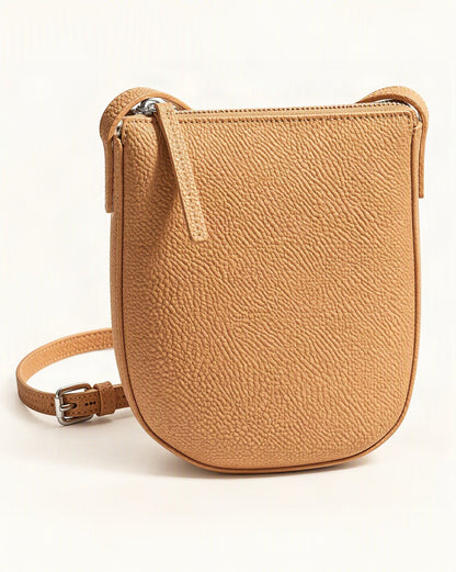 Cowhide Leather Mini Crossbody Phone Bag — front three-quarter view on a warm white background