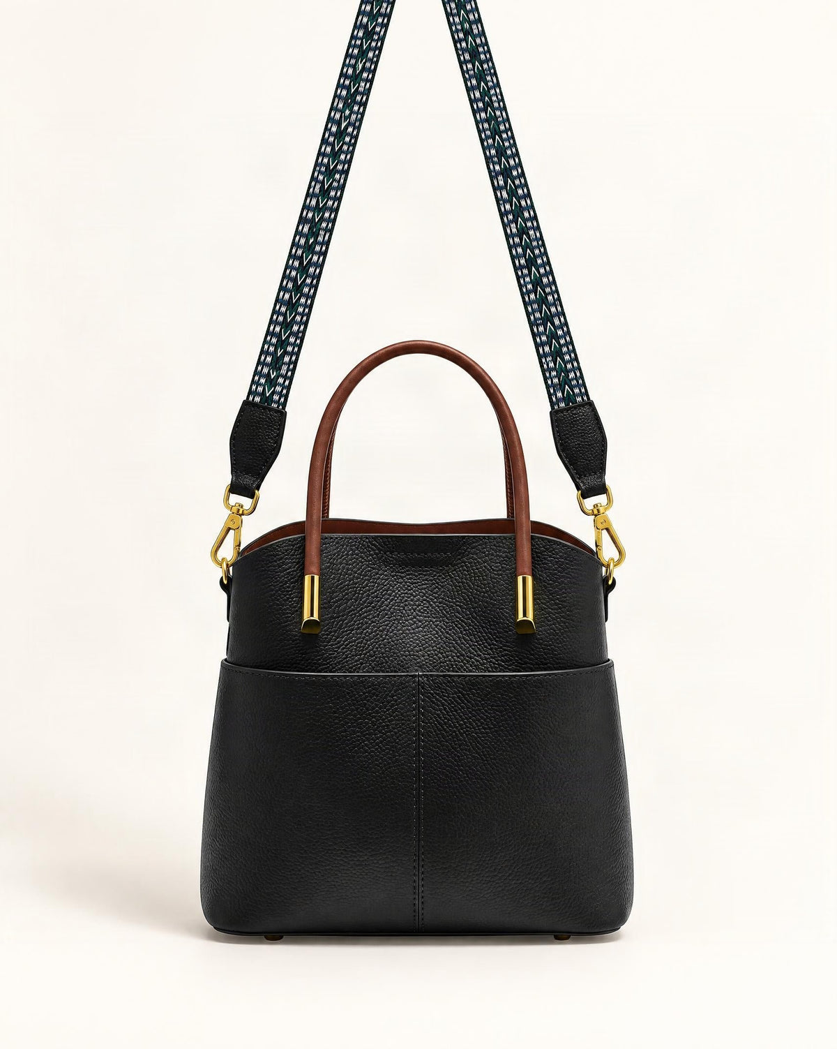 Cowhide Leather Bucket Bag with Woven Strap — straight-on front view on a warm white background