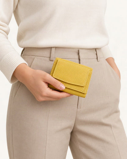 Cowhide Tri-Fold RFID-Blocking Wallet held in hand by a model