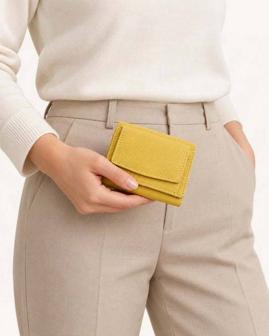 Cowhide Tri-Fold RFID-Blocking Wallet held in hand by a model
