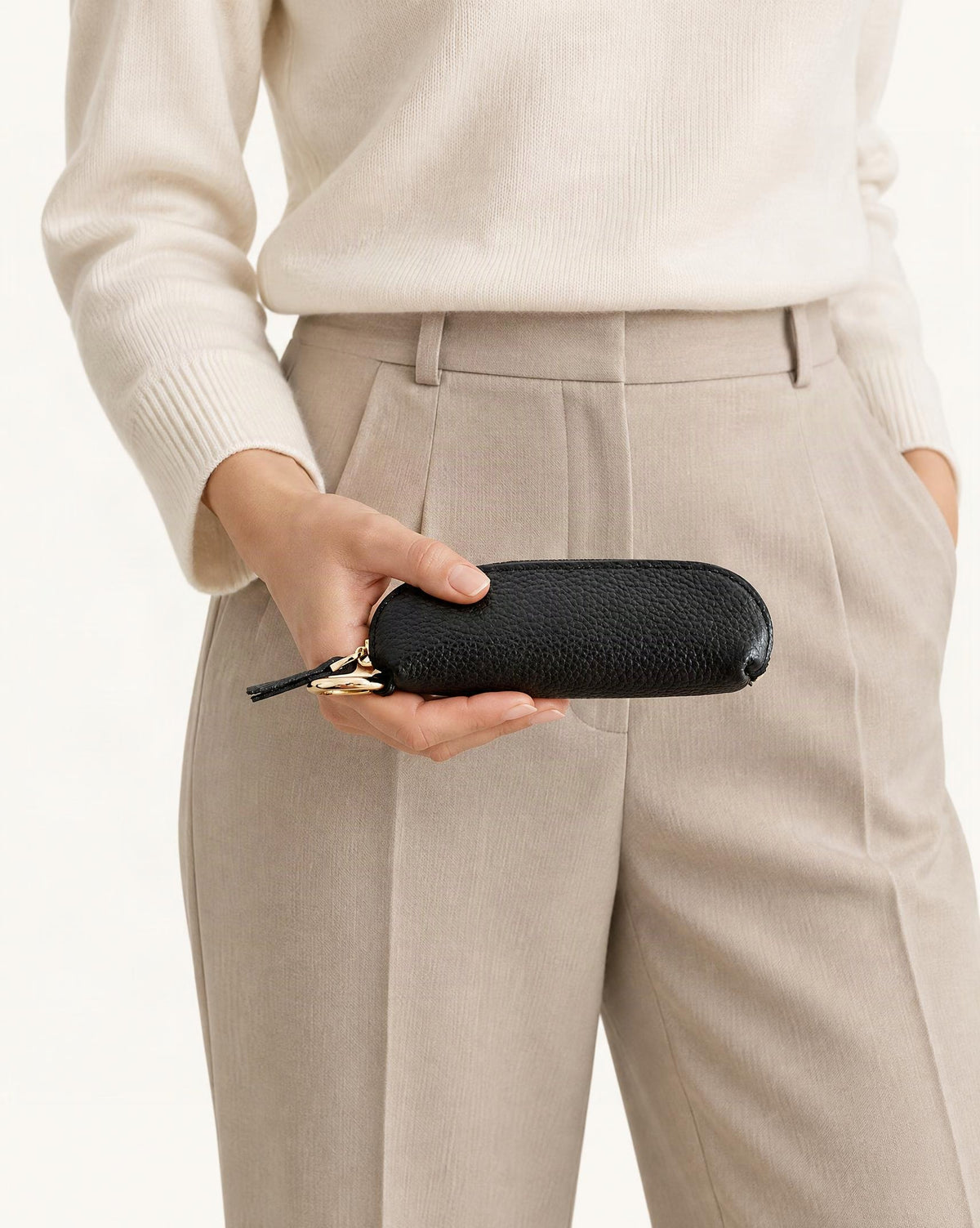 Top-Grain Cowhide Mini Zip Pouch with Keyring Clip held in hand by a model