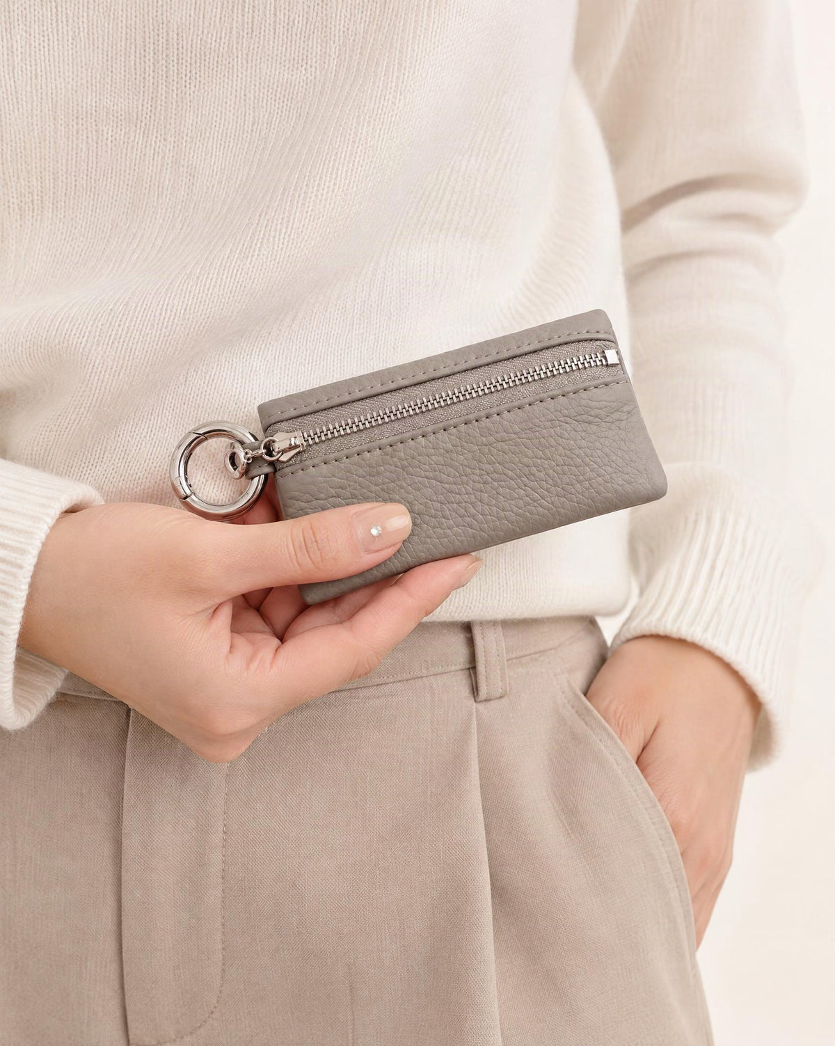 Cowhide Leather Key Chain Coin Pouch held in hand by a model