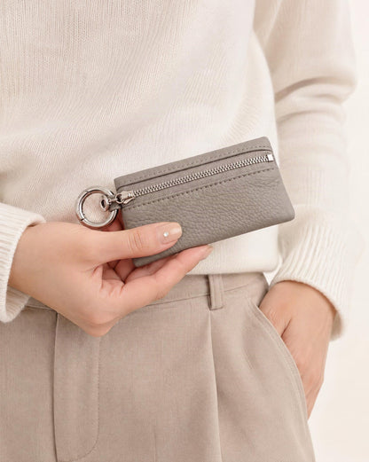 Cowhide Leather Key Chain Coin Pouch held in hand by a model