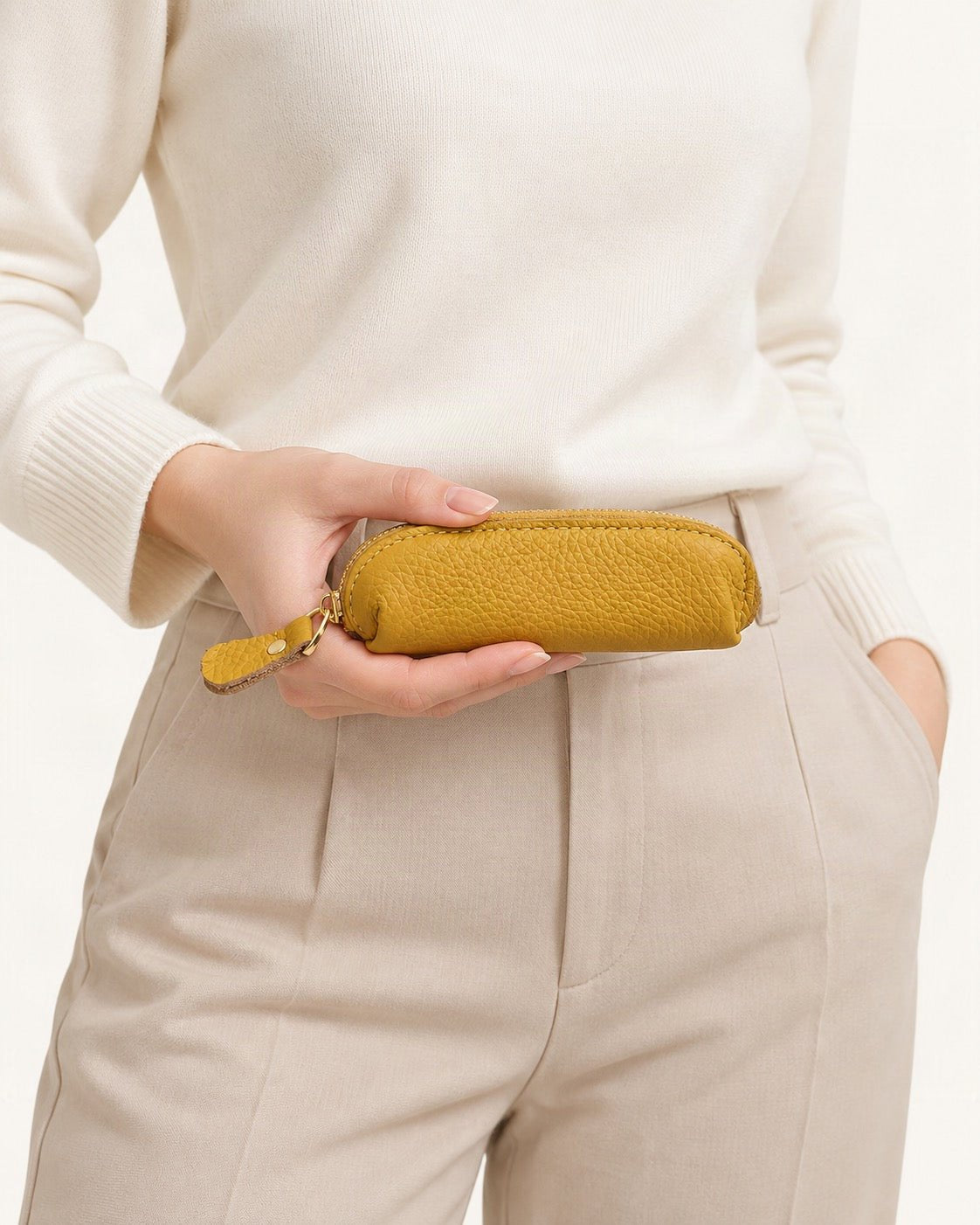 Genuine Leather Mini Coin Pouch with Zipper held in hand by a model