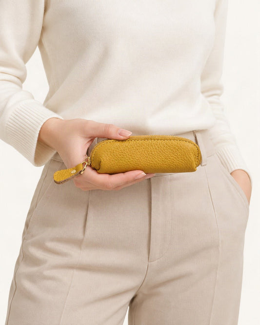 Genuine Leather Mini Coin Pouch with Zipper held in hand by a model