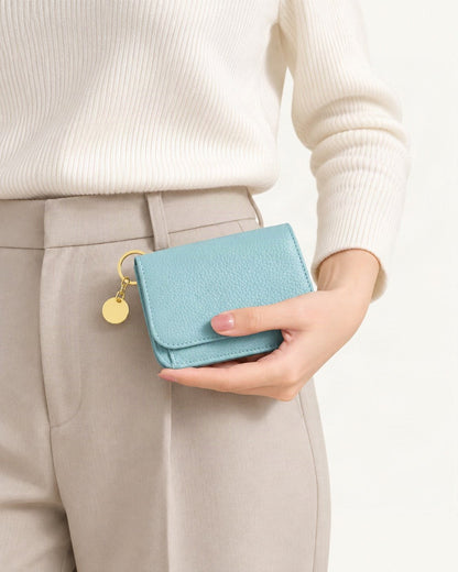 Genuine Leather RFID-Blocking Mini Wallet with Keyring Charm held in hand by a model