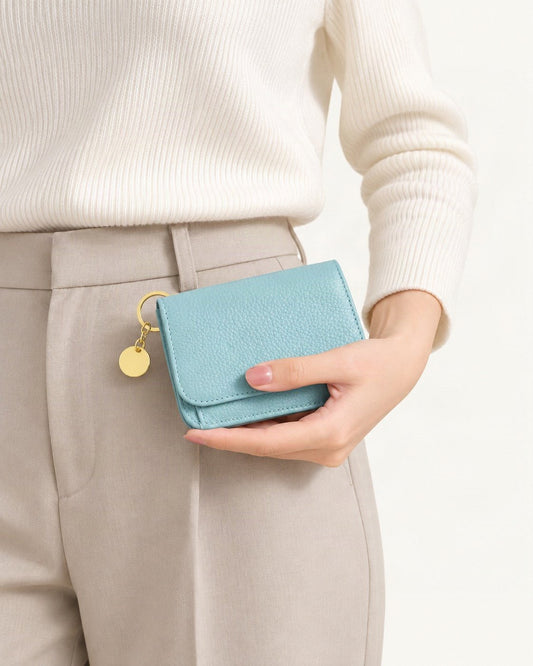 Genuine Leather RFID-Blocking Mini Wallet with Keyring Charm held in hand by a model