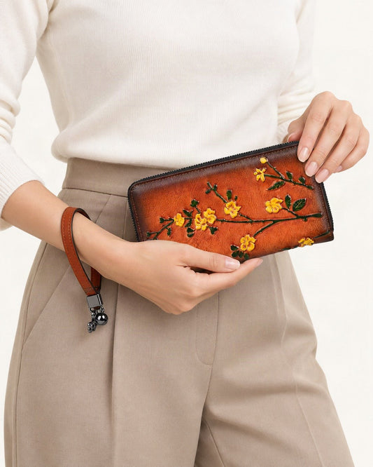 Top-Grain Cowhide Wristlet Wallet held in hand by a model