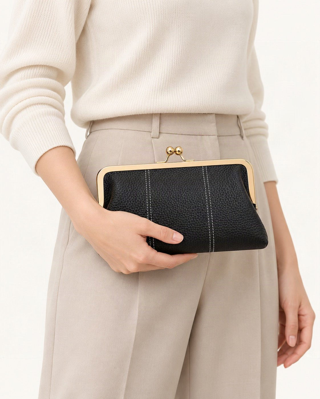 Top-Grain Cowhide Frame Clutch held in hand by a model