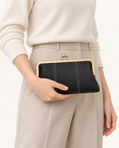 Top-Grain Cowhide Frame Clutch held in hand by a model