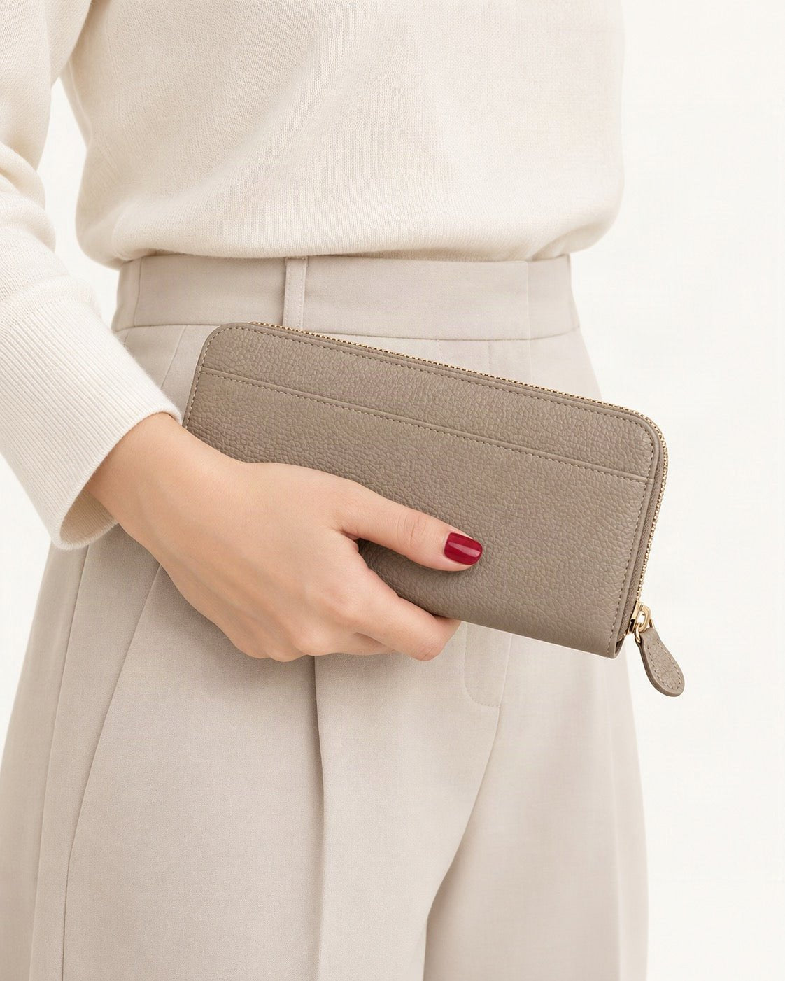 Top-Grain Cowhide Zip-Around Long Wallet with RFID Blocking held in hand by a model