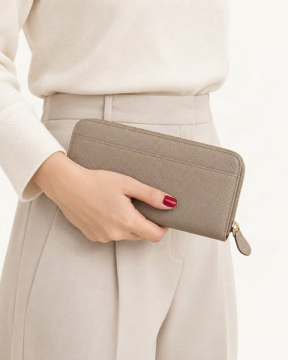 Top-Grain Cowhide Zip-Around Long Wallet with RFID Blocking held in hand by a model