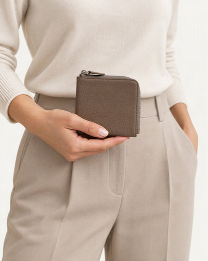 Cowhide Leather Short RFID-Blocking Wallet held in hand by a model