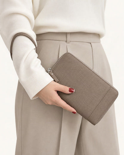 Genuine Leather RFID Passport Holder Wallet with Wrist Strap held in hand by a model