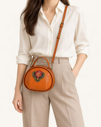 Cowhide Embossed Round Crossbody Bag worn crossbody