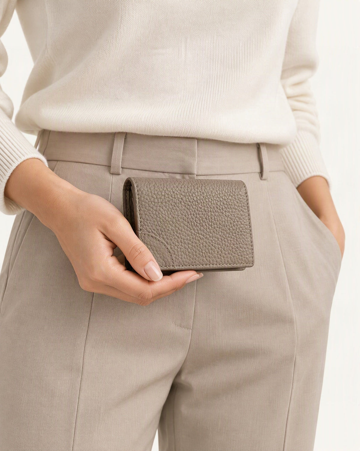 Cowhide Leather Mini Bifold Card Holder Wallet held in hand by a model