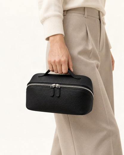 Top-Grain Cowhide Cosmetic Pouch held in hand by a model