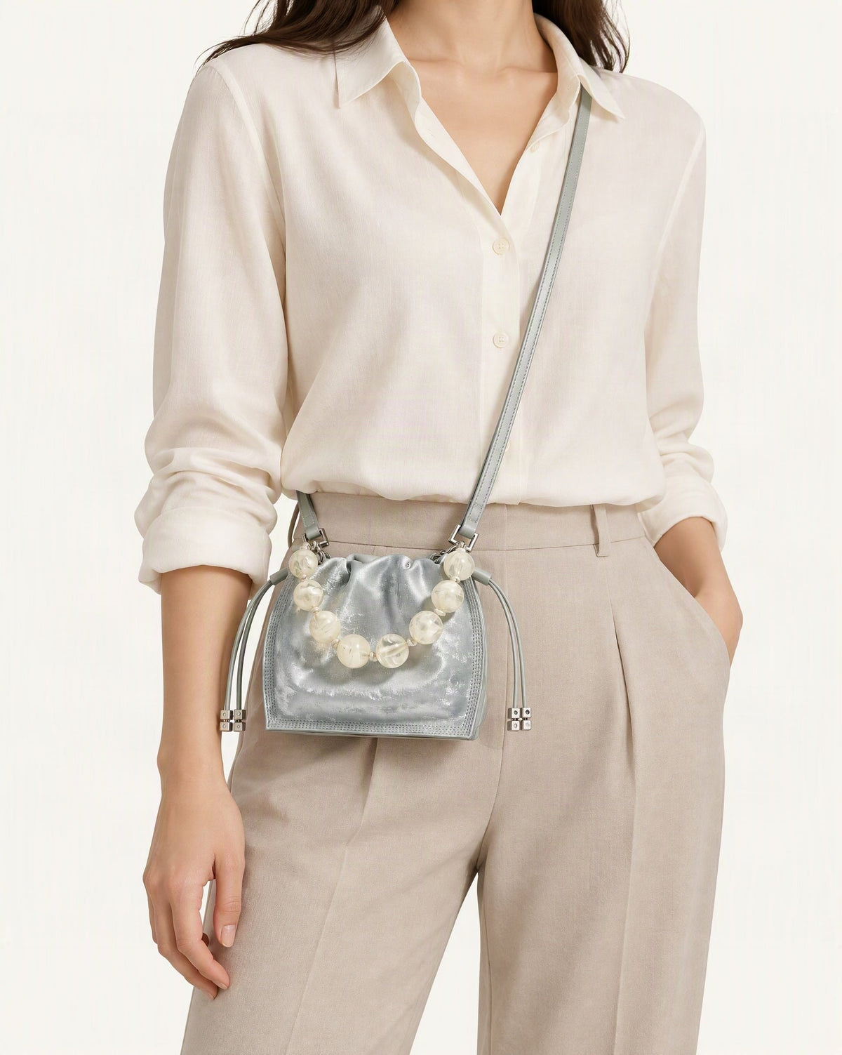 Cowhide Mini Bucket Bag Crossbody Drawstring Bead Handle worn crossbody