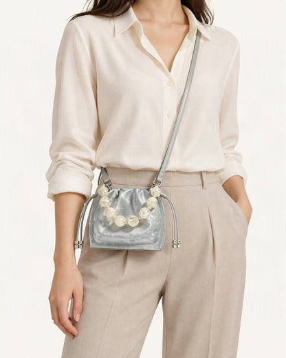 Cowhide Mini Bucket Bag Crossbody Drawstring Bead Handle worn crossbody
