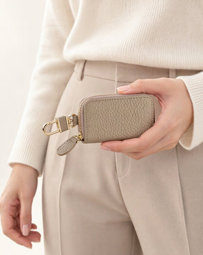 Genuine Leather Zip-Around Key Pouch with Carabiner Clip held in hand by a model