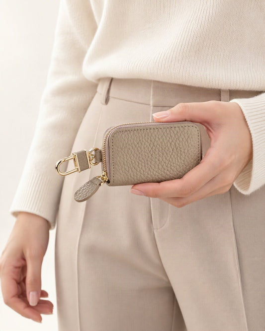 Genuine Leather Zip-Around Key Pouch with Carabiner Clip held in hand by a model