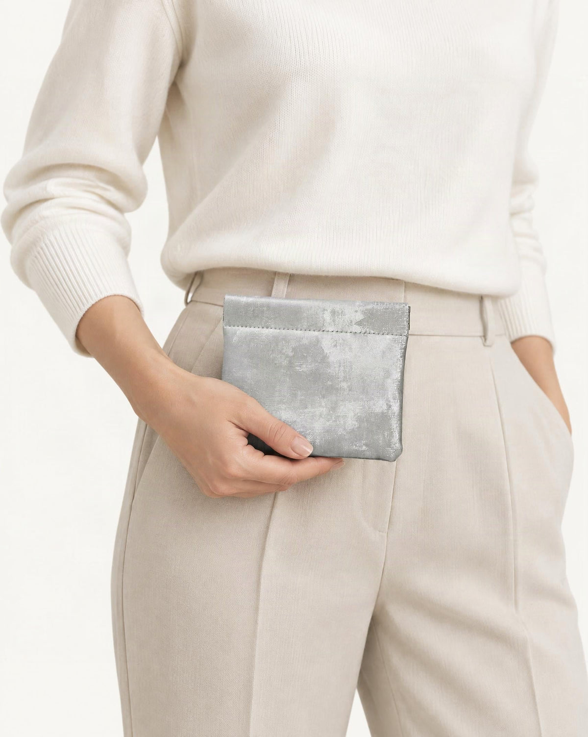 Satin Cowhide Mini Card Pouch with Spring Clasp Closure held in hand by a model