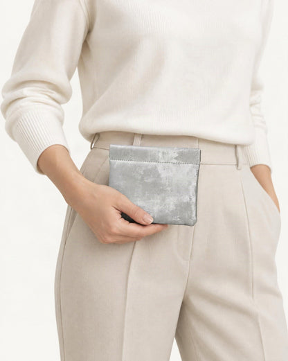 Satin Cowhide Mini Card Pouch with Spring Clasp Closure held in hand by a model