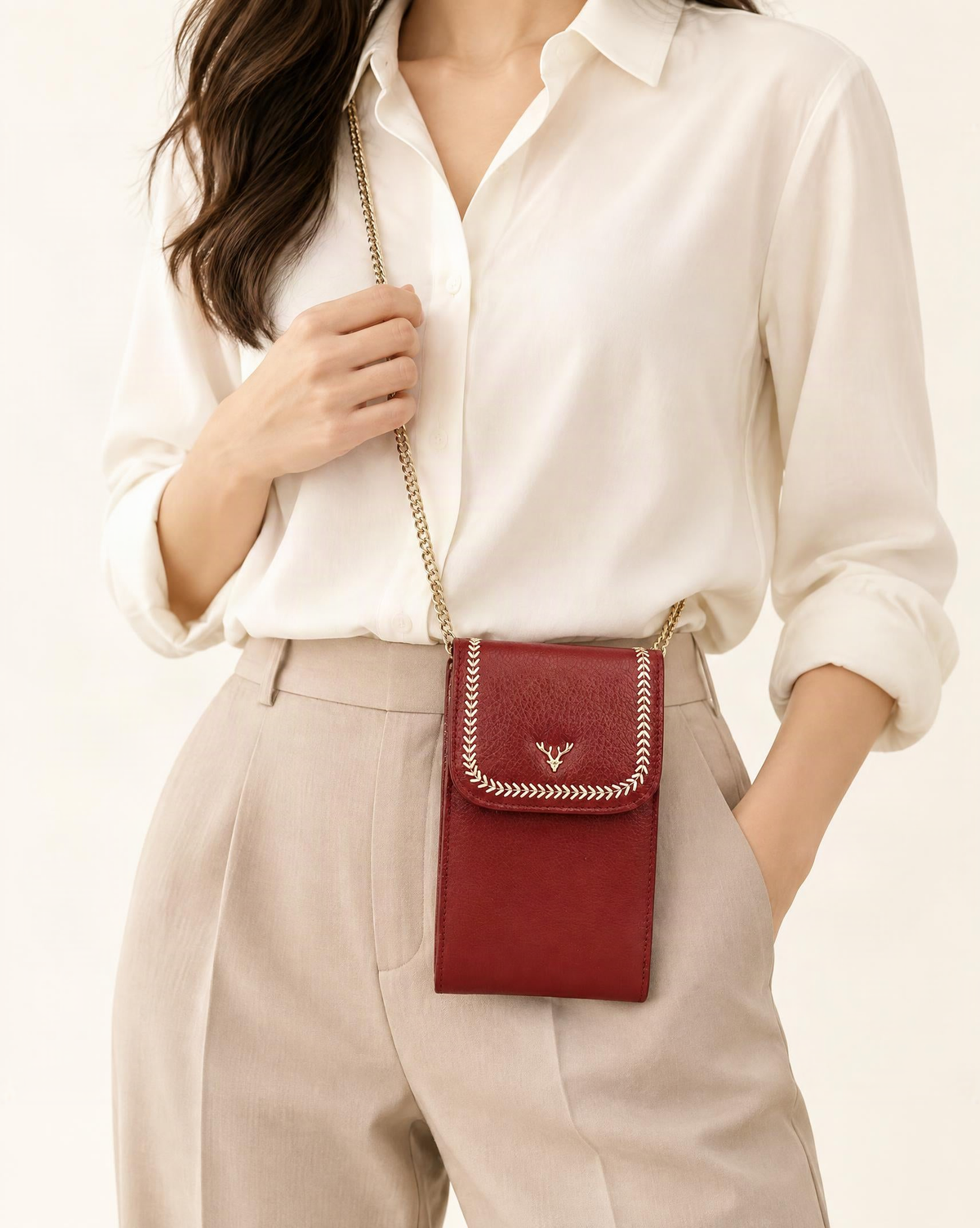 Top-Grain Cowhide Micro Crossbody Phone Bag with Chain Strap worn crossbody