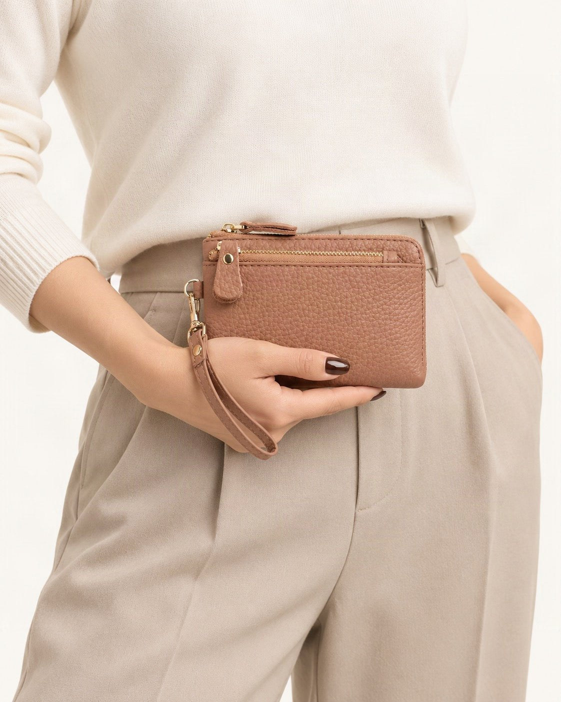 Genuine Leather Mini Clutch Wallet held in hand by a model
