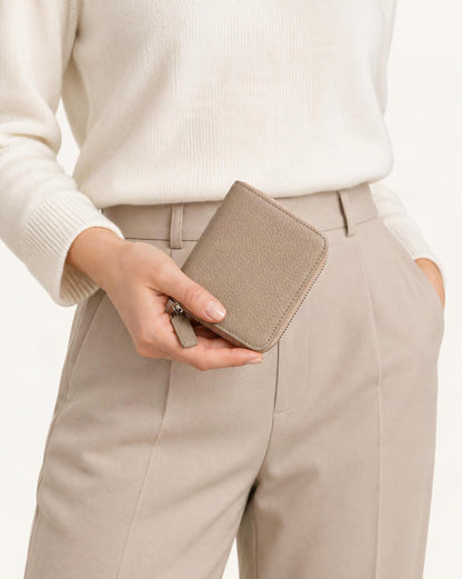 Cowhide Leather Compact Bi-Fold Wallet held in hand by a model