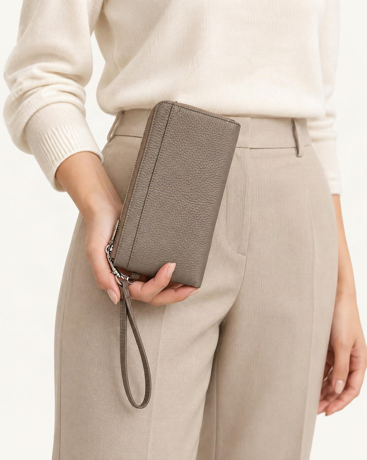 RFID-Blocking Pebbled Cowhide Long Zip Clutch held in hand by a model