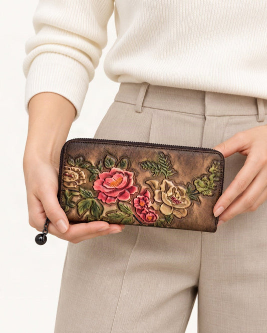 Cowhide Zip-Around Wallet Floral held in hand by a model