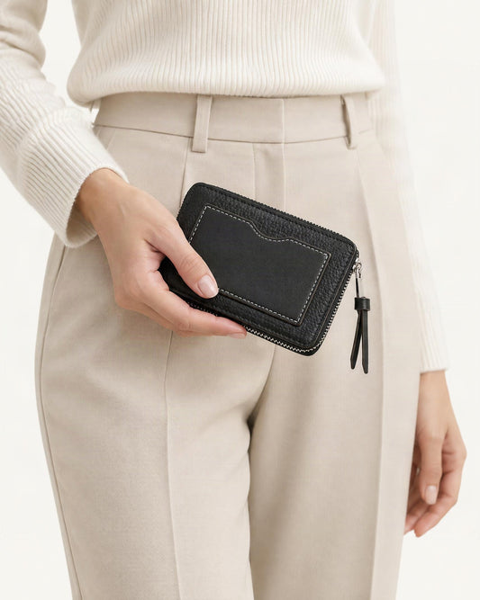 Cowhide Mini Card Holder Wallet w Zip Coin Pocket held in hand by a model