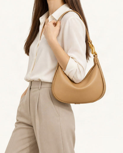Cowhide Crescent Underarm Bag with X Buckle worn crossbody