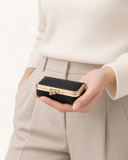 Top-Grain Cowhide Lipstick and Jewelry Pouch with Mirror held in hand by a model