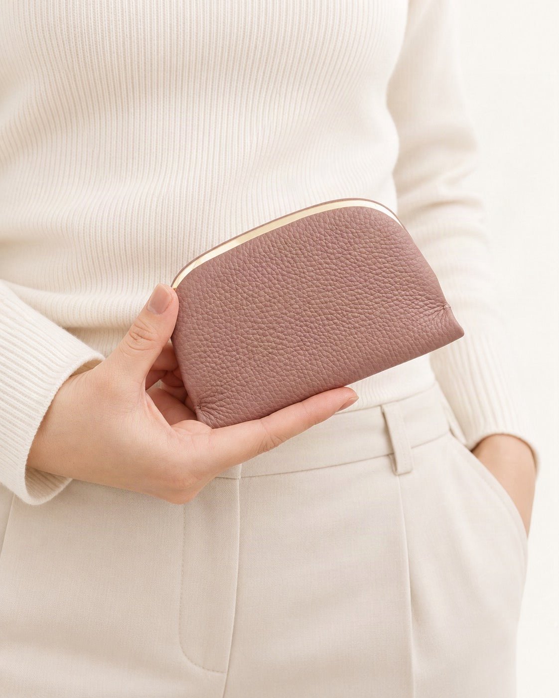 Top-Grain Cowhide Coin Purse held in hand by a model