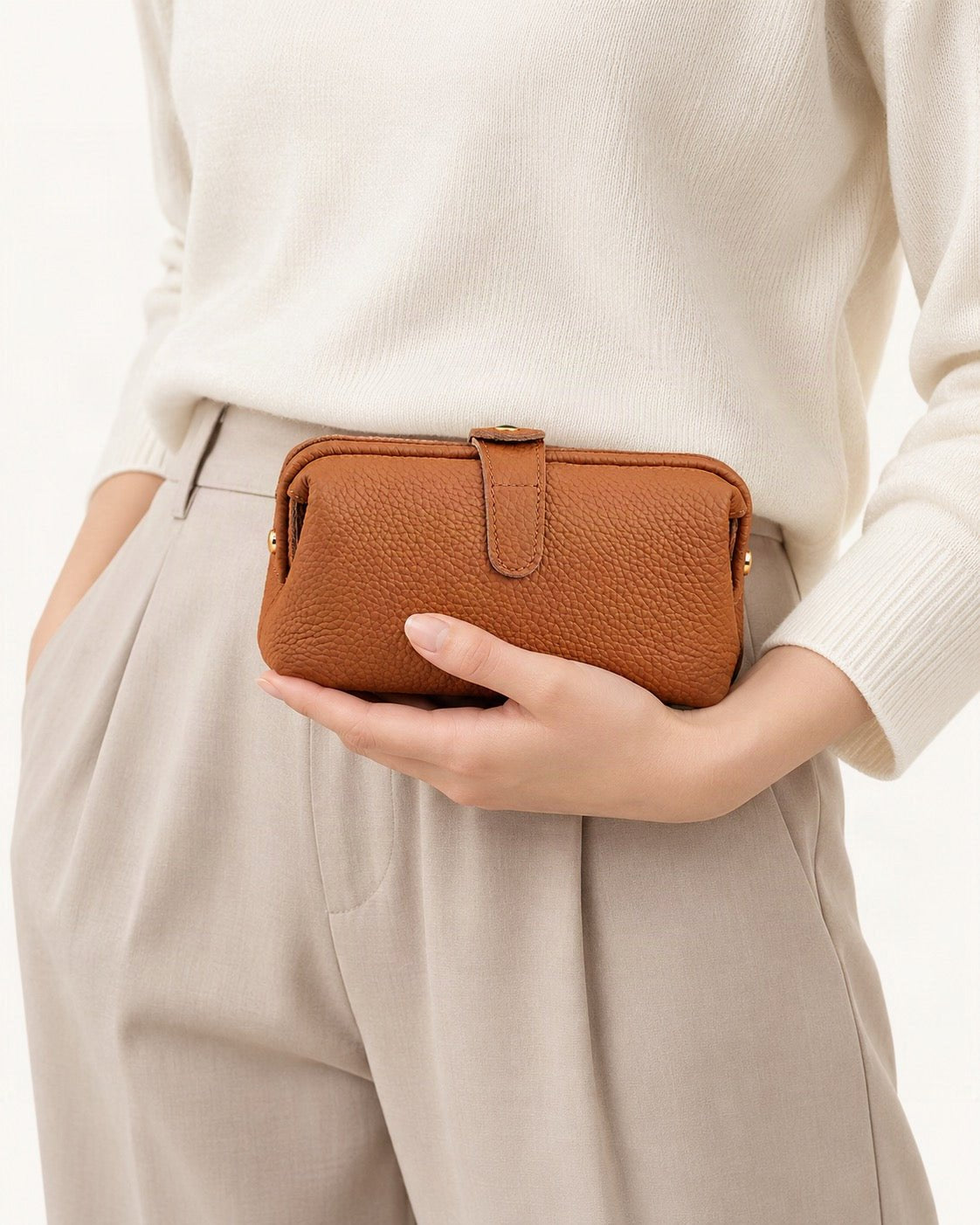 Top-Grain Cowhide Cosmetic Pouch – Color Options held in hand by a model