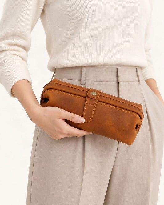 Top-Grain Cowhide Cosmetic Pouch held in hand by a model