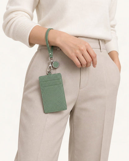 Leather Slim ID Badge Holder with Reel & Strap held in hand by a model