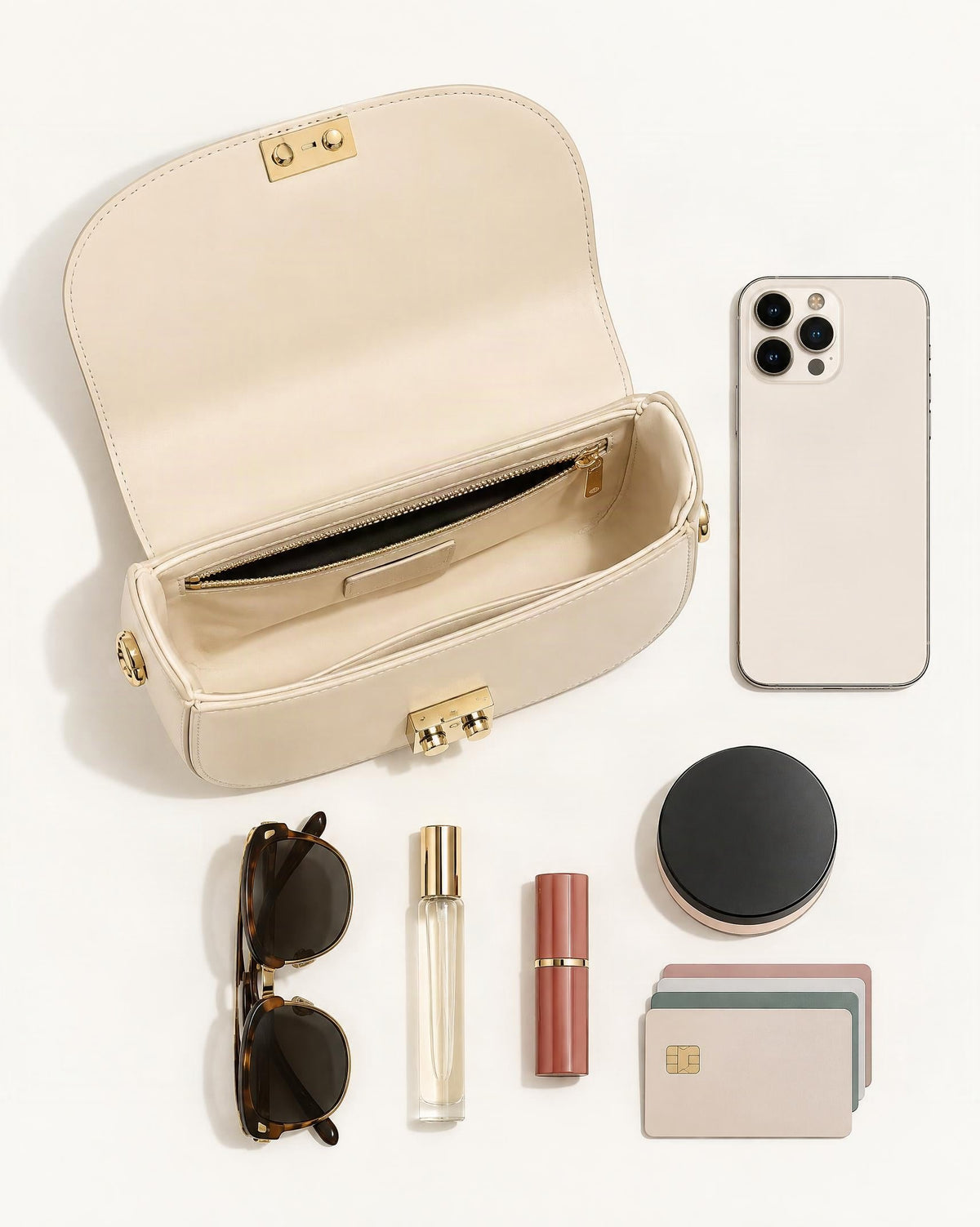 What fits in the Cowhide Leather Mini Saddle Crossbody Bag with Push Lock: smartphone up to 6.9 in, folded sunglasses, a 10 ml travel perfume, a lipstick, a compact powder, cards