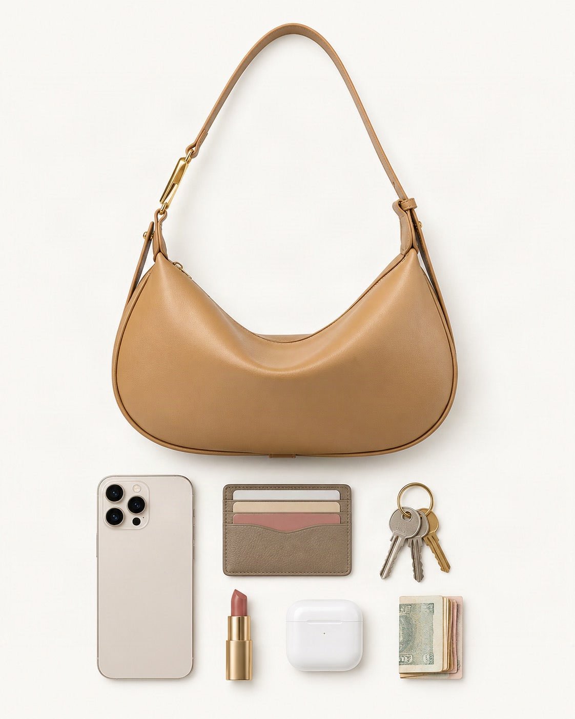 What fits in the Cowhide Crescent Underarm Bag with X Buckle: smartphone up to 6.9 in, cards, keys, a lipstick, airpods in their case, a few banknotes folded over into a small stack, no complete flat bill face showing