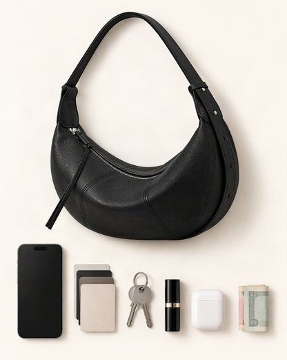What fits in the Cowhide Leather Crescent Hobo Crossbody Bag: smartphone up to 6.9 in, cards, keys, a lipstick, airpods in their case, a few banknotes folded over into a small stack, no complete flat bill face showing