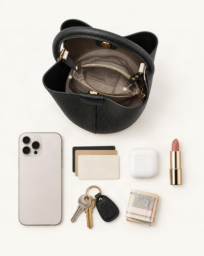 What fits in the Top-Grain Cowhide Mini Bucket Bag: smartphone up to 6.9 in, cards, keys, a lipstick, airpods in their case, a few banknotes folded over into a small stack, no complete flat bill face showing