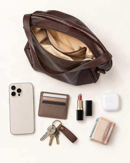 What fits in the Cowhide Leather Tote Shoulder Bag with Detachable Strap: smartphone up to 6.9 in, cards, keys, a lipstick, airpods in their case, a few banknotes folded over into a small stack, no complete flat bill face showing