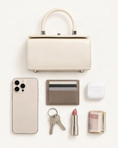 What fits in the Cowhide Leather Box Handbag: smartphone up to 6.9 in, cards, keys, a lipstick, airpods in their case, a few banknotes folded over into a small stack, no complete flat bill face showing