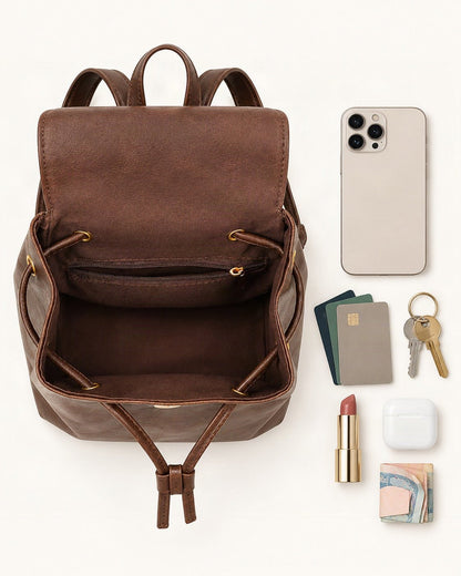 What fits in the Split Cowhide Mini Backpack: smartphone up to 6.9 in, cards, keys, a lipstick, airpods in their case, a few banknotes folded over into a small stack, no complete flat bill face showing