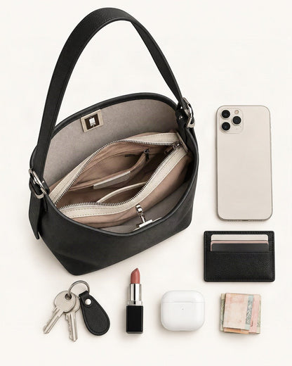 What fits in the Top-Grain Cowhide Leather Bucket Bag, 7.9 x 9.1 x 4.7 in: smartphone up to 6.9 in, cards, keys, a lipstick, airpods in their case, a few banknotes folded over into a small stack, no complete flat bill face showing