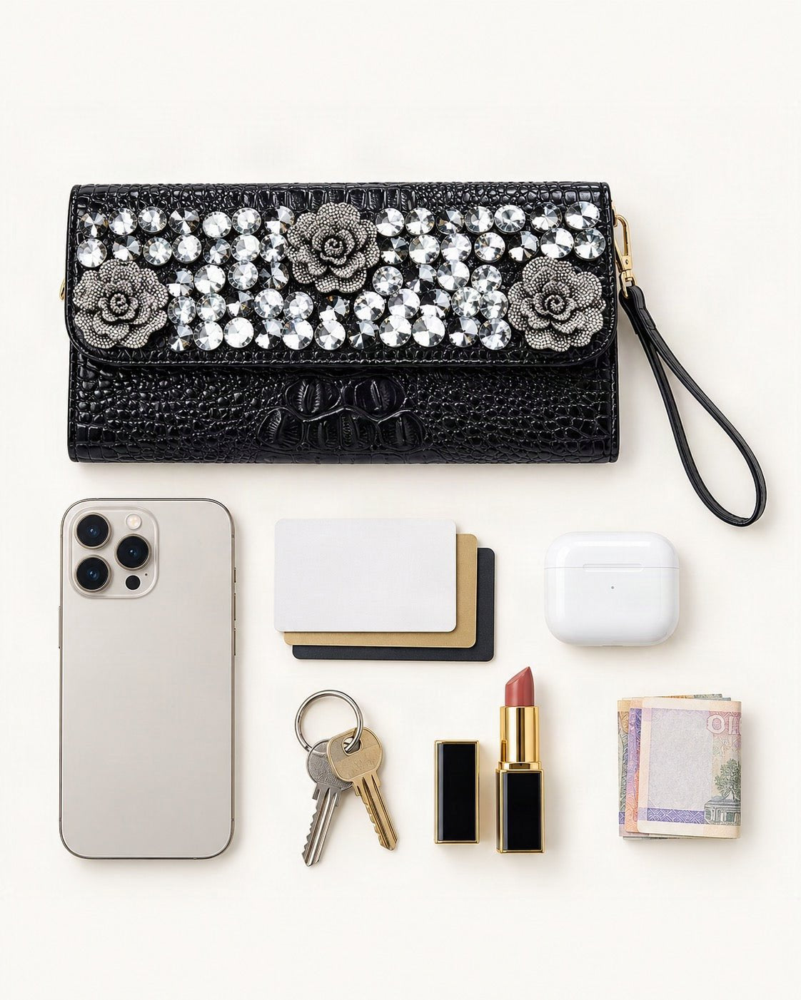 What fits in the Split Leather Embellished Clutch: smartphone up to 6.9 in, cards, keys, a lipstick, airpods in their case, a few banknotes folded over into a small stack, no complete flat bill face showing